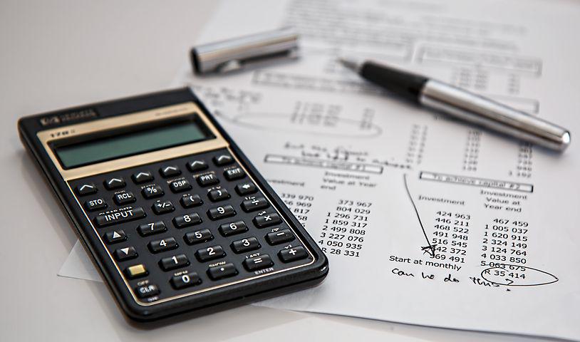 a calculator placed on top of a financial report