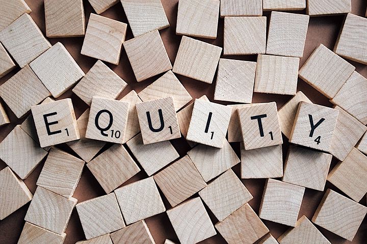 equity of a financial statement is spelled out in wooden blocks on top of a bunch of letter less blocks